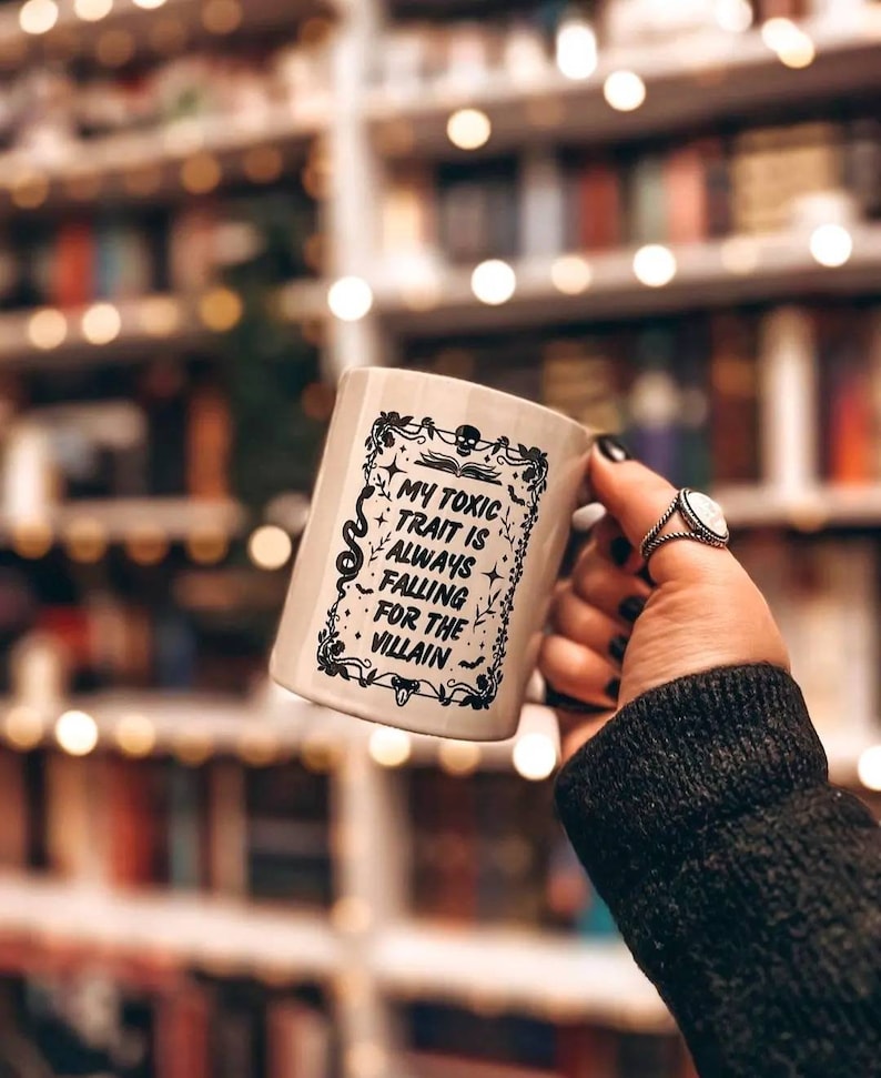 Falling for the villain ceramic mug with black handle