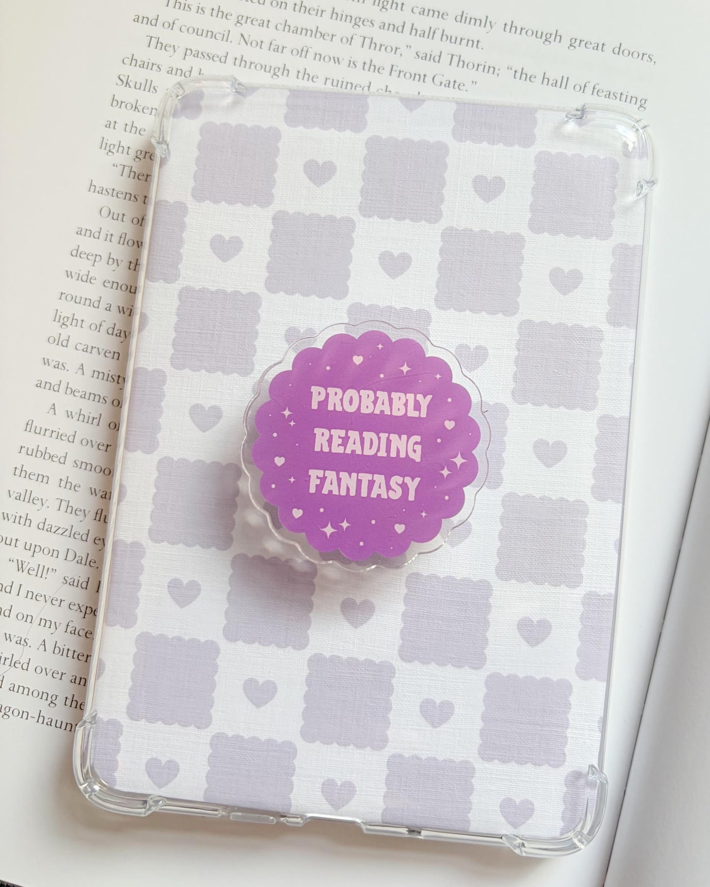 Probably reading fantasy kindle/phone grip