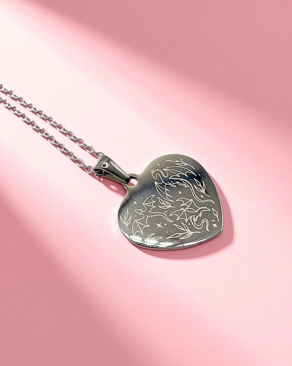 Silver colour heart shaped dragon engraved necklace